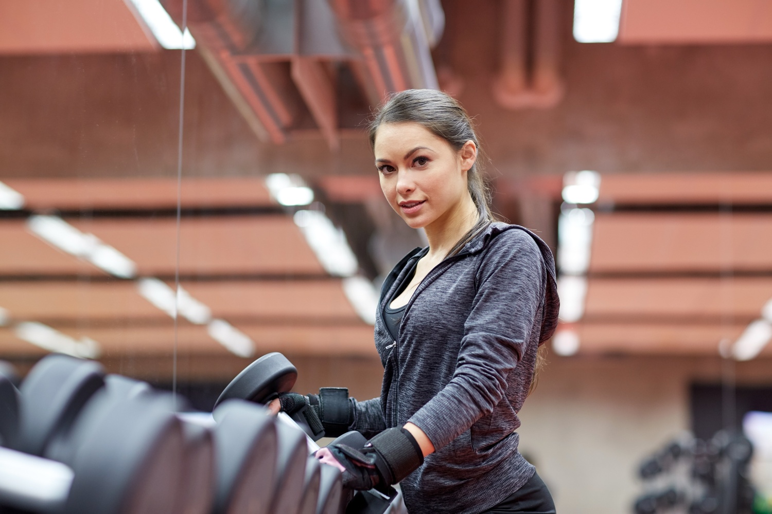 fitness-sport-exercising-weightlifting-people-concept-young-woman-choosing-dumbbells-gym